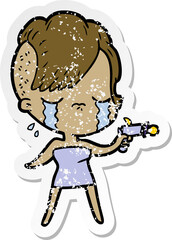 distressed sticker of a cartoon crying girl pointing ray gun