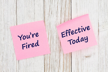 Youre Fired Effective Today message on yellow sticky note for your job firing