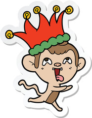 sticker of a crazy cartoon monkey wearing jester hat