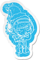 cartoon distressed sticker of a pretty astronaut girl wearing santa hat