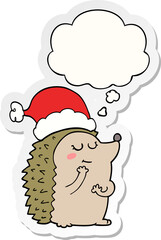 cartoon hedgehog wearing christmas hat and thought bubble as a printed sticker