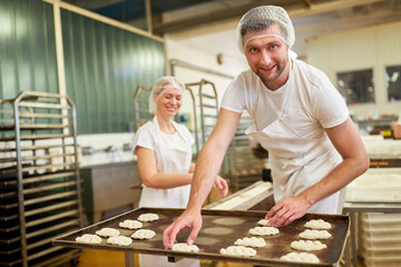 Baker apprentice in training makes yeast braids