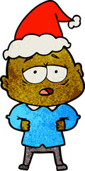 textured cartoon of a tired bald man wearing santa hat