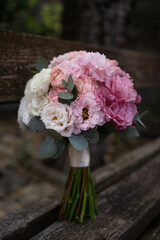 Wedding bouquet composed of roses, ozothamnus, freesia and eucalyptus. Pink bridal bouquet. Wedding day.