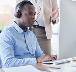 Black man, call center and coach by computer for training in telemarketing, customer service or support at office. African American male intern consultant working on desktop PC with mentor in sales