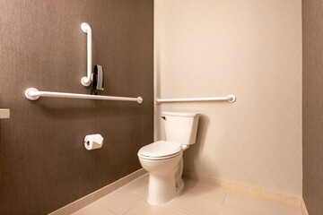 Wheelchair accessible hotel bathroom shower with tile floor and walls.