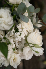 Wedding bouquet of white flowers - ranunculus, freesia, lisianthus.. Wedding. Bride and groom.