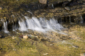 Fototapeta na wymiar Natural waterfall over rocks
