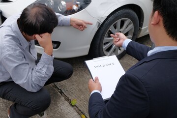 Loss Adjuster Insurance Agent Inspecting Damaged Car.