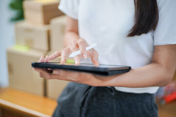 Business From Home Asian woman preparing package delivery box Shipping for shopping online. young start up small business owner at home online order