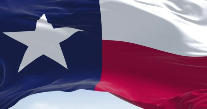 Seamless loop in slow motion of the Texas state flag fluttering in the wind