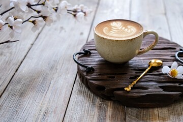 a cup of coffee latte on a wooden table