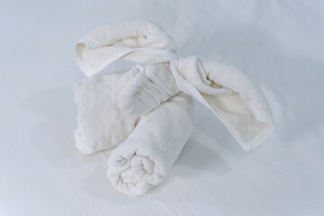 Beautifully folded clean white bath towels set folding fabric into elephant shape on the bed neatly clean bed of the hotel room coziness textile the hotel.