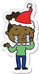 sticker cartoon of a crying woman wearing santa hat