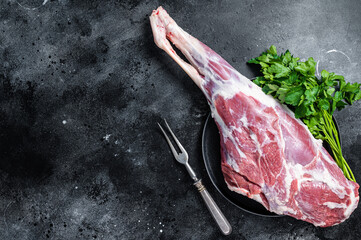 Ready for cooking  raw lamb mutton leg with Thigh. Black background. Top view. Copy space