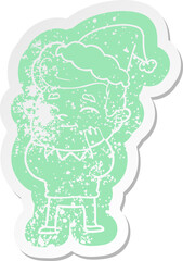 happy cartoon distressed sticker of a man wearing santa hat