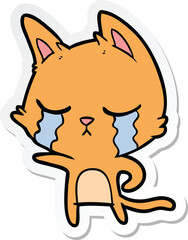 sticker of a crying cartoon cat pointing