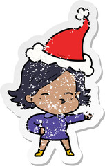 distressed sticker cartoon of a woman pointing wearing santa hat