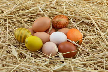 close view of painted easter eggs on wheat straw