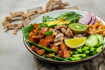 Vegan Chinese and Japanese salad with vegetables and fried tofu. buddha bowl. Vegan lunch salad, Food recipe background. Close up