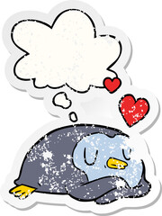 cartoon penguin in love and thought bubble as a distressed worn sticker