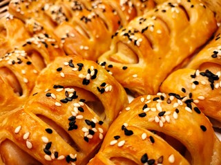Black and white sesame seeds on bread. Closeup of fresh bread stuffed with whole grains and selective focus. food concept
