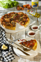 pizza with sauce on the table