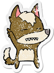distressed sticker of a cartoon wolf waving showing teeth