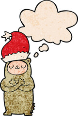 cartoon bear wearing christmas hat and thought bubble in grunge texture pattern style