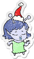 cute alien girl distressed sticker cartoon of a wearing santa hat