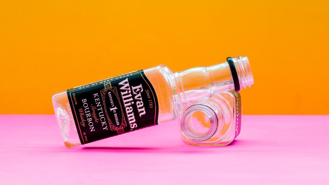 NORWALK, CT, USA -  MARCH, 21, 2023:  Two empty bottle from Evan Williams whiskey on colorful background
