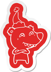 cartoon  sticker of a bear showing teeth wearing santa hat