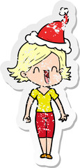 distressed sticker cartoon of a happy woman wearing santa hat