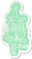 happy cartoon distressed sticker of a alien dancing wearing santa hat