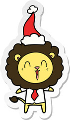 laughing lion sticker cartoon of a wearing santa hat