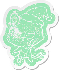 bored cartoon distressed sticker of a cat wearing santa hat