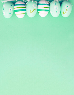easter colorful handmade painted eggs on green background with copy space. banner