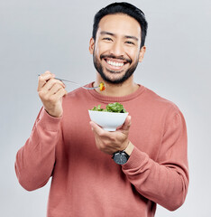 Man, salad and eating healthy portrait in studio for wellness food motivation with vegetables....