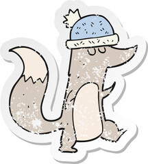 retro distressed sticker of a cartoon little wolf wearing hat