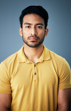 Confidence, serious and portrait of a man in studio with depression, sadness or mental health problem. Tired, exhausted and Indian male model with burnout face expression isolated by gray background.