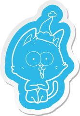 funny cartoon  sticker of a cat wearing santa hat