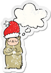 cartoon bear wearing christmas hat and thought bubble as a distressed worn sticker