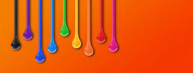 Colorful ink drops on orange background. Horizontal banner