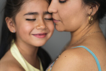 close up portrait of a mother and her super cute little girl