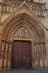 Valencia, Spain - October 15, 2022: Cathedral of Valencia on the Square of the Blessed Virgin. Urban landscape. Ancient Architecture, Brick House.