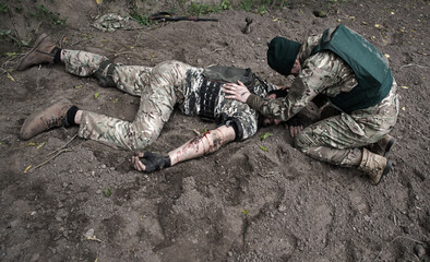 The friend cries at wounded soldier