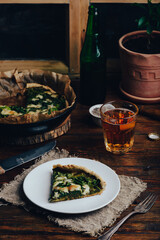 Slice of Spinach Tart with Parmesan Cheese and Chives