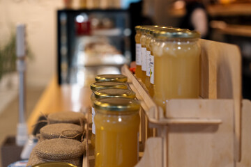 The interior of a bakery and coffee shop honey in jars on the shelves