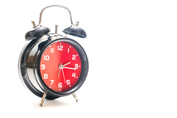A red and black alarm clock