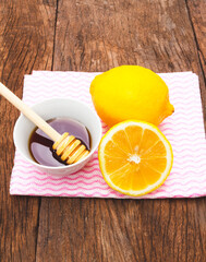Tea with lemon and honey on the wooden background.